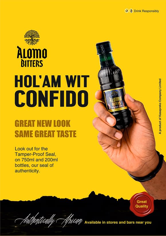 Hand holding Alomo Bitters drink