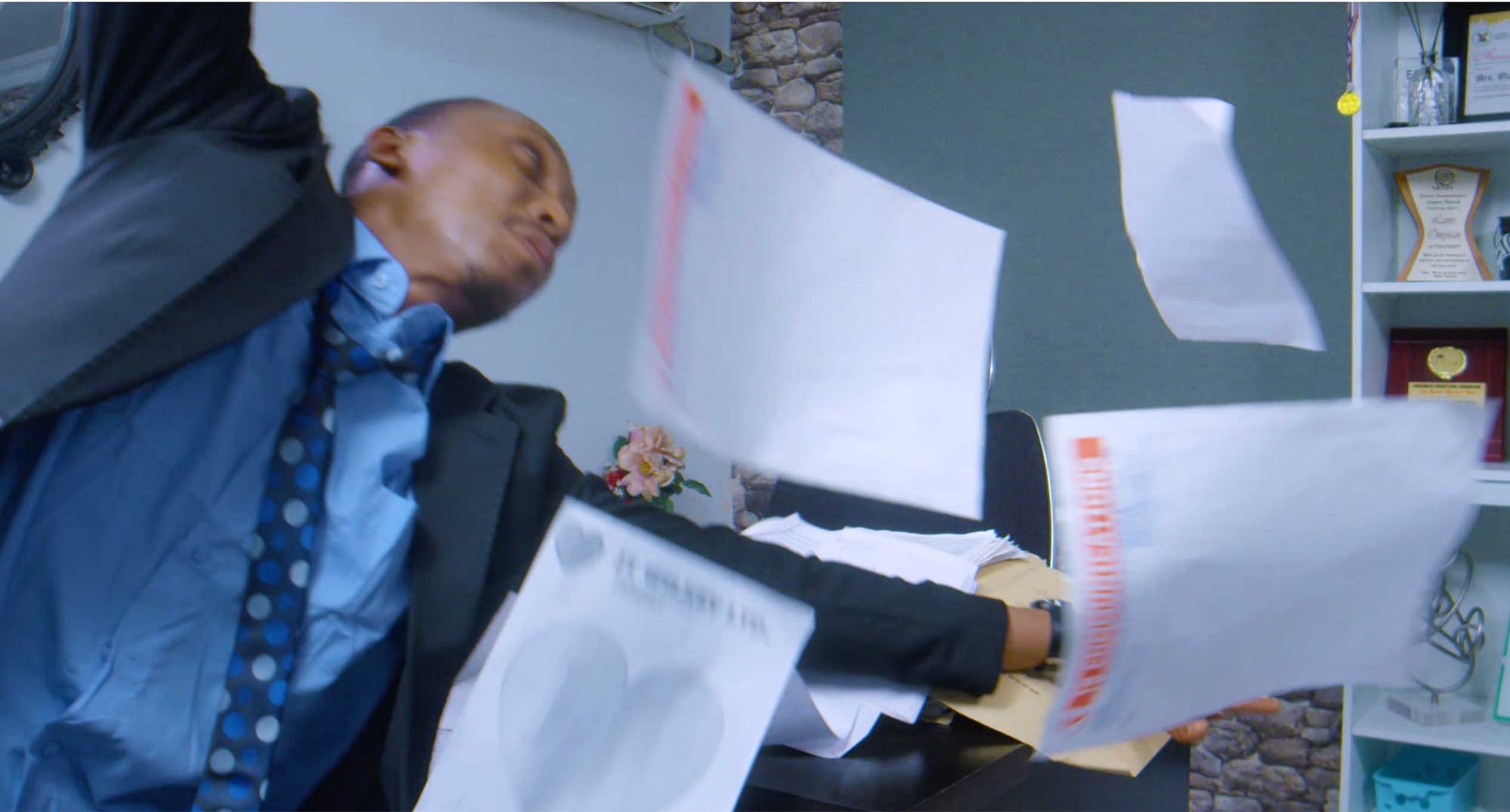 Frank Donga trying to catch flying paper